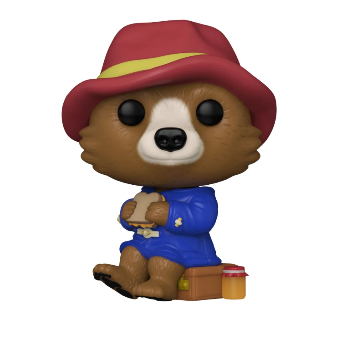 En esta imagen podemos ver el Funko Paddington 1480, en esta figura destaca el sombrero que lleva puesto el oso y el bocadillo que se esta comiendo mientras, esta sentado.